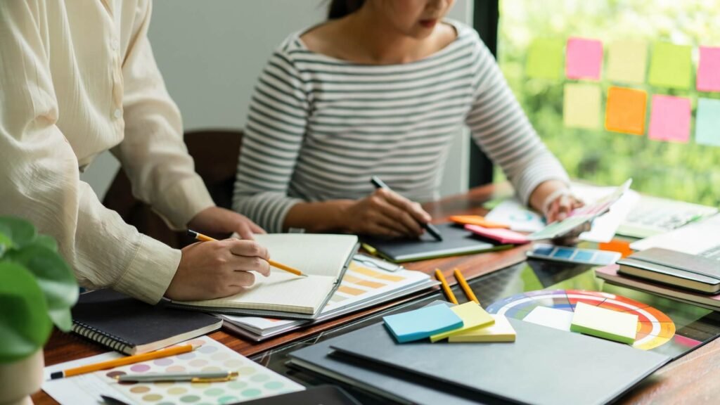 two creative graphic designers hold color swatches q84vuym.jpg